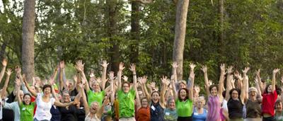A group of people jumping in the air, Brisbane skyline in the background.
