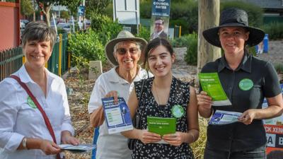 People at a polling booth, voting.
