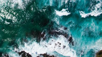 Header image: Coral reef, ocean waves, blue water, sunny sky.