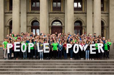 People holding signs on steps, Fitzroy Town Hall, Melbourne.