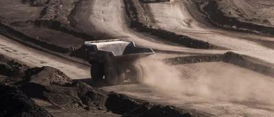 Coal trucks on a road, transporting coal.